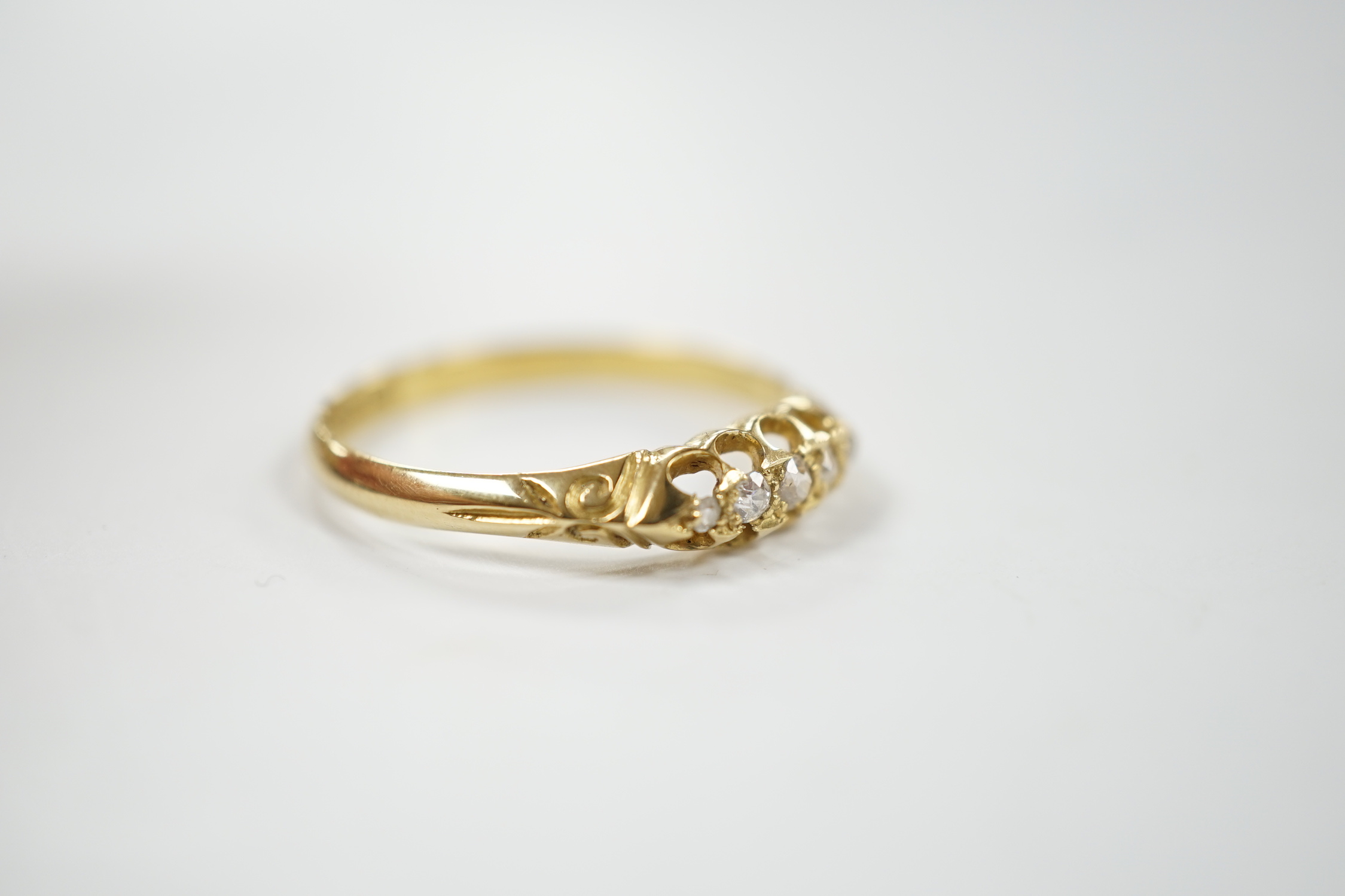 A Victorian 18ct gold and graduated five stone diamond chip set half hoop ring, size X, gross weight 3.6 grams.